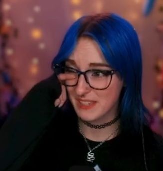 kat wiping away a tear from their eye 