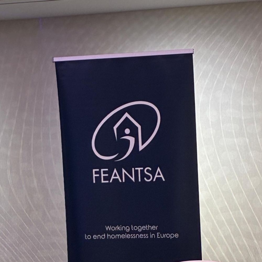 Image shows a banner stand, which says 'FEANTSA: working together to end homelessness in Europe' on it.