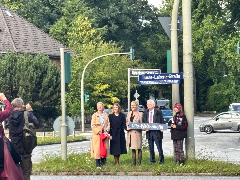 Fünf Personen, die Reden auf der Feierstunde hielten, stehen am neu enthüllten Straßenschild 