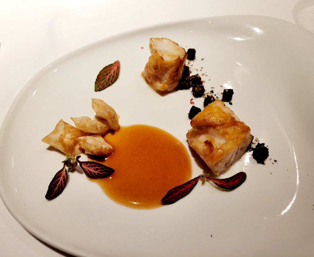 A 'fine dining' plate of monkfish, celeriac pillows, seaweed and pink pepper with an apple sauce.