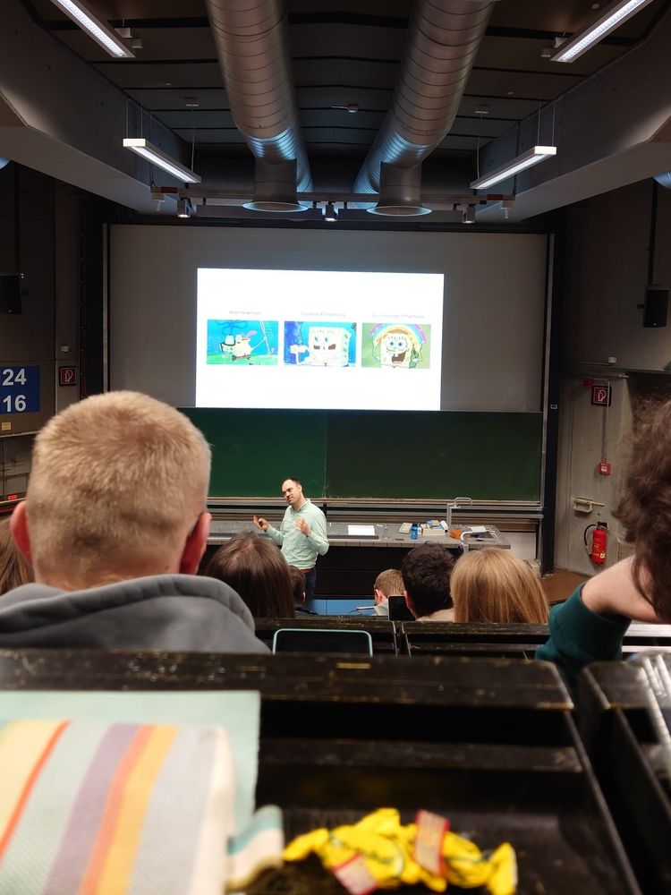 Lecture slide, audience and lecturer.