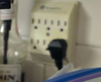 A bunch of eletrical plugs resembling astonished faces, cropped from the original photo.