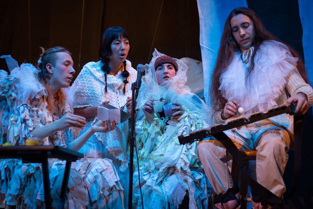 Four members of Stay Well Magdalena perform on a stage. 