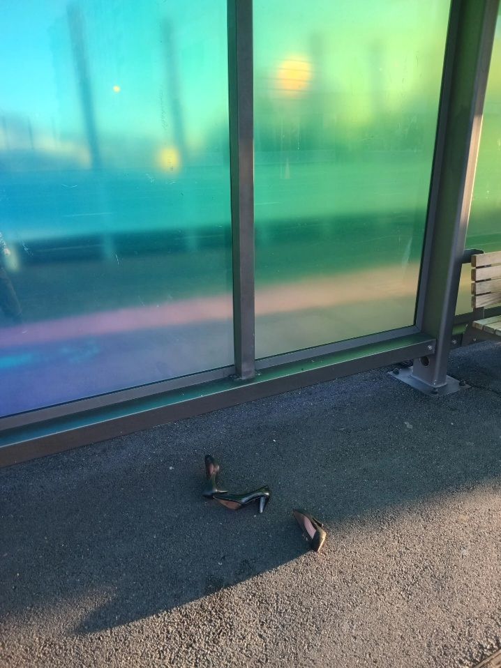 Three ladies high heel shoes discarded in the street