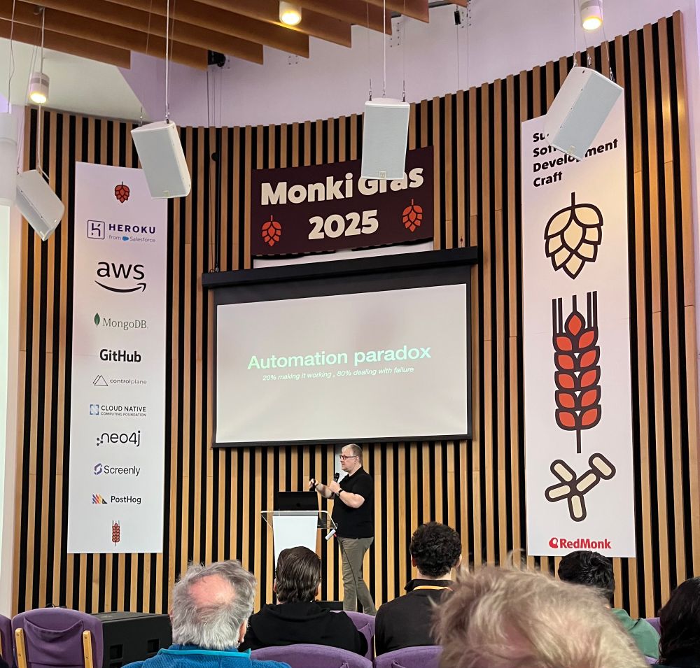 Photo of Patrick Debois at Monki Gras 2025 in front of a slide saying “Automation Paradox”