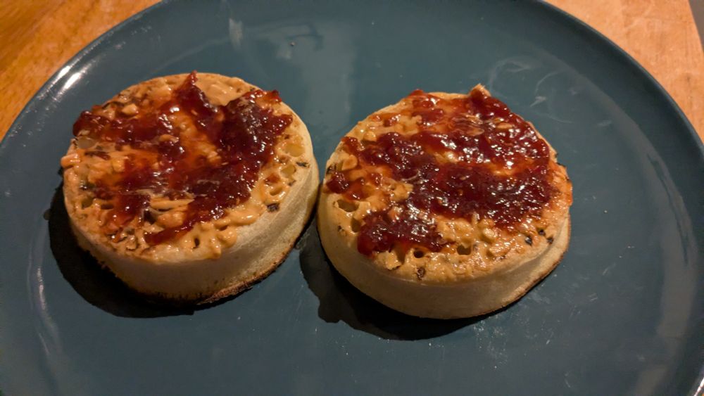 Crumpets with peanut butter and raspberry jam.