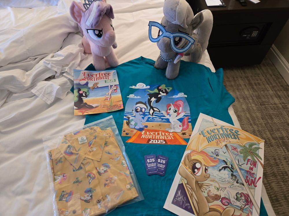 Di & Silvy help me showcase the Sponsor package for Everfree Northwest 2025: convention attendee T-shirt (in teal), a short-sleeve button-up shirt (in ochre) printed with the convention mascots, convention poster by guest of honor Sara Richard (@ladysararichard.bsky.social), and $50 in con merch store vouchers