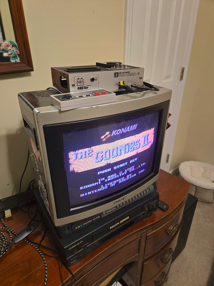 My FPGA MiSTer (it's in the custom silver-and-woodgrain case on top of the TV), hooked to a 13" Sony Trinitron KV-1365 TV from 1985. 