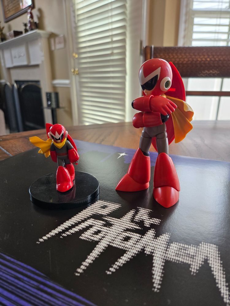A couple of Proto Man figures, standing atop the vinyl sleeve for The Protomen's self-titled debut album. 

Left: Bandai Tamashii Nations Chozoukei Damashii Blind Mystery Box Proto Man (2011)

Right: Kotobukiya Mega Man Proto Man (Blues) (plastic model kit) (2011)