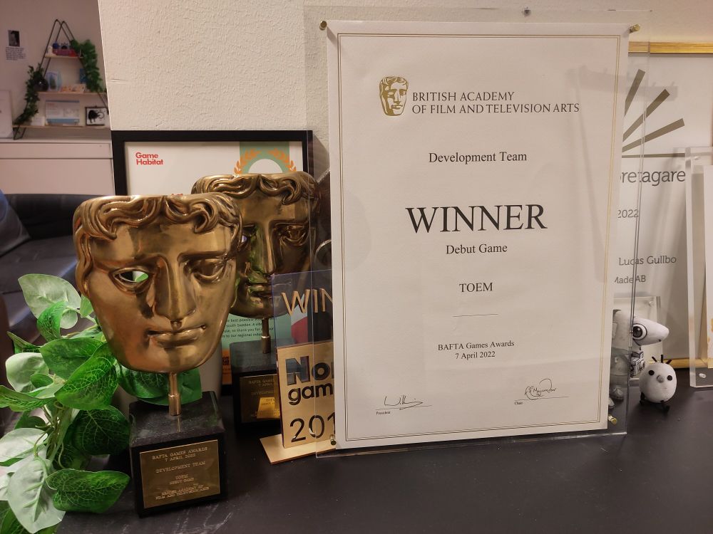 Photo of a BAFTA trophy along with its certificate 