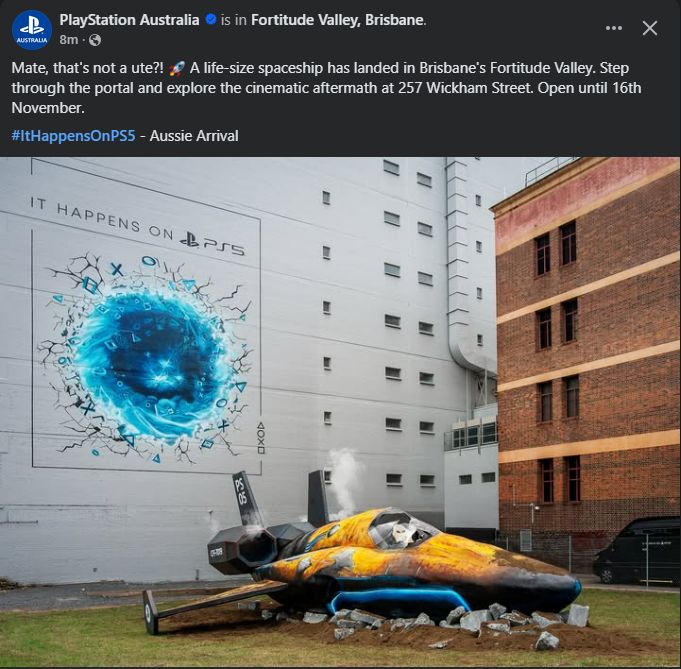 A facebook post from Playstation Australia promoting a large on site display. The image posted is of a spacecraft crashed on the ground that's gone through a blue portal.