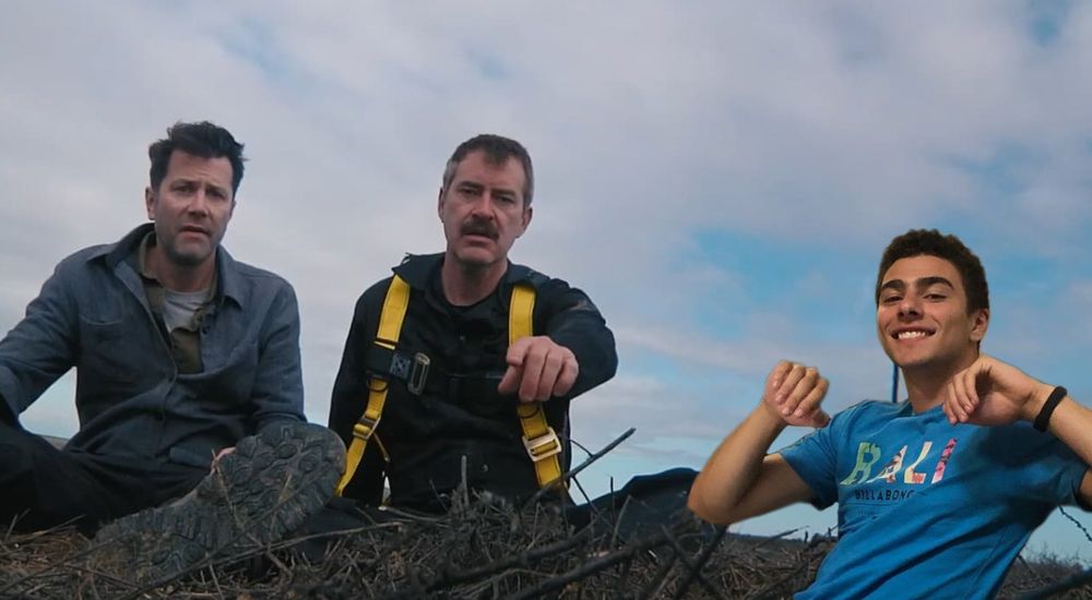 Luigi Mangione posing with Mark Duplass and David Nordstrom between takes in ep.2