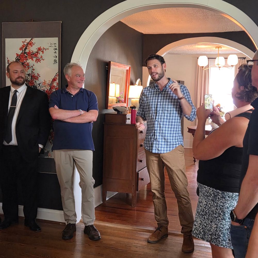 Photo of LCDC Chair Ryan Ruzic, U.S. Senator Tim Kaine, and candidate for Delegate, John McAuliff, inside a home 