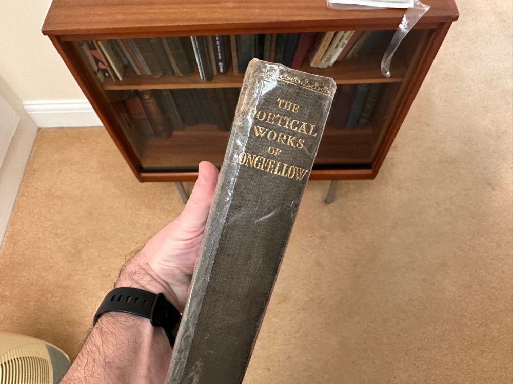 The spine of a copy of The Poetical Works of Longfellow. 