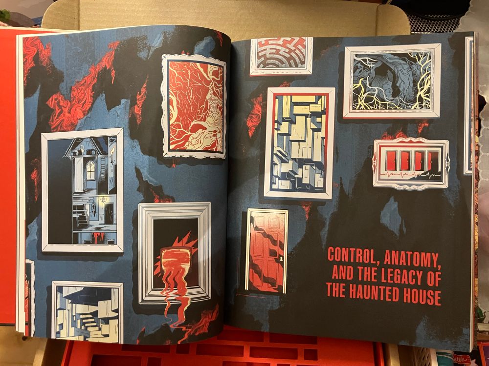 the book flipped open to the “control, anatomy, and the legacy of the haunted house” cover page, with art done by yours truly!