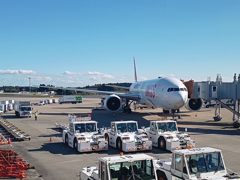 Swiss Boeing 777-300ER registration HB-JNL parked at the gate at Tokyo Narita airport on a cold but beautiful sunny day after arriving from Zurich