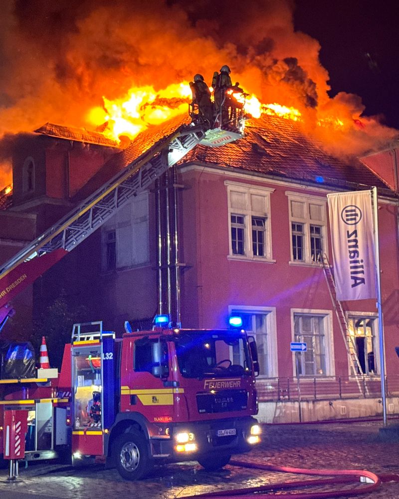 Alte Operette Dresden, aus dem Dachstuhl steigen Flammen empor, im Vordergrund eine Feuerwehr mit Drehleiter löscht den Brand am Dach, gegen 23 Uhr 