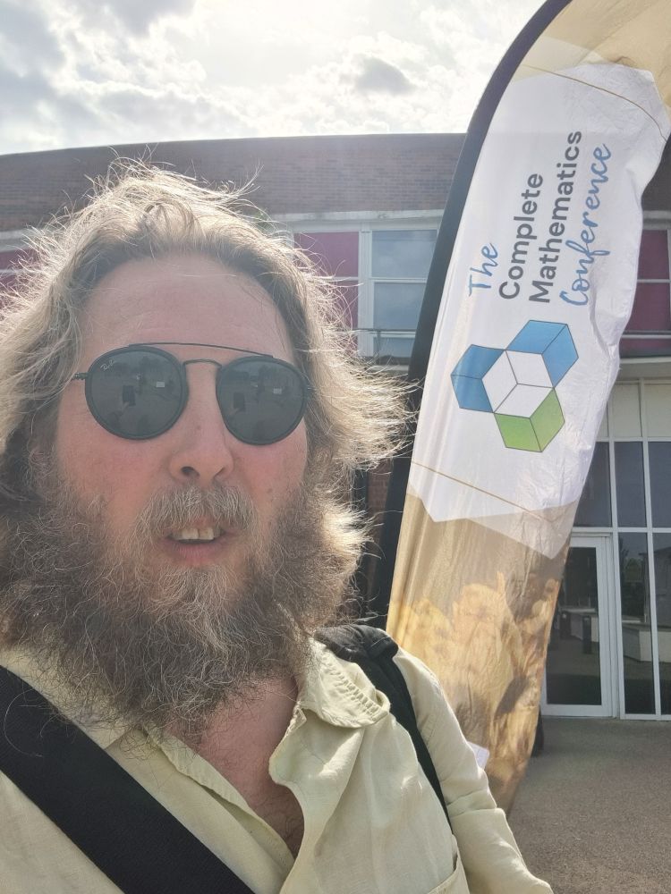 Me in front of the complete maths banner