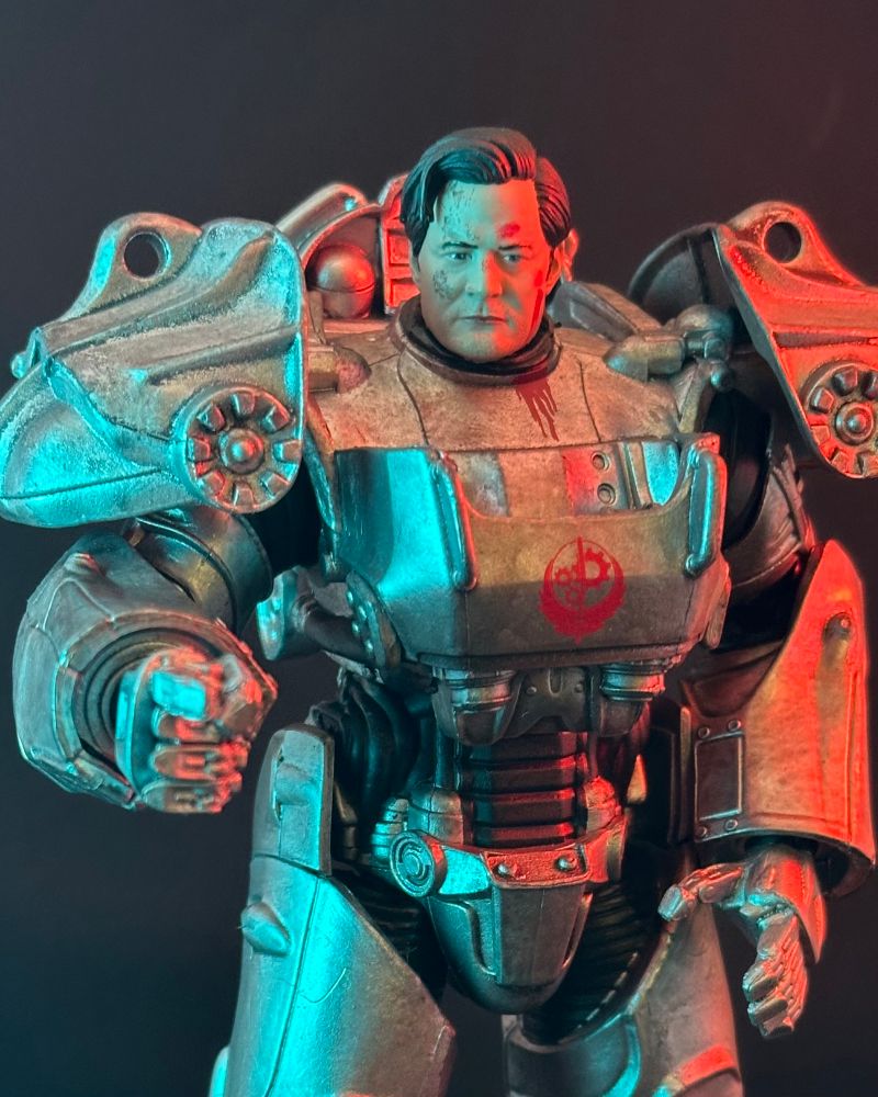 an action figure of Kyle MacLachlan as Hank MacLean from the Fallout TV show, suited in power armor and pointing emphatically