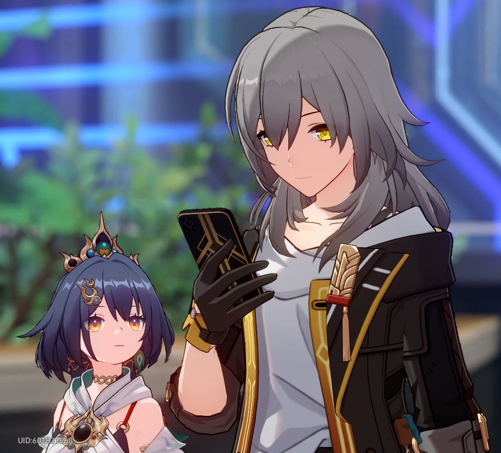 A cropped screenshot from Honkai: Star Rail, featuring one of the main characters (Stelle) holding her smartphone, and character Yunli peeking at it.