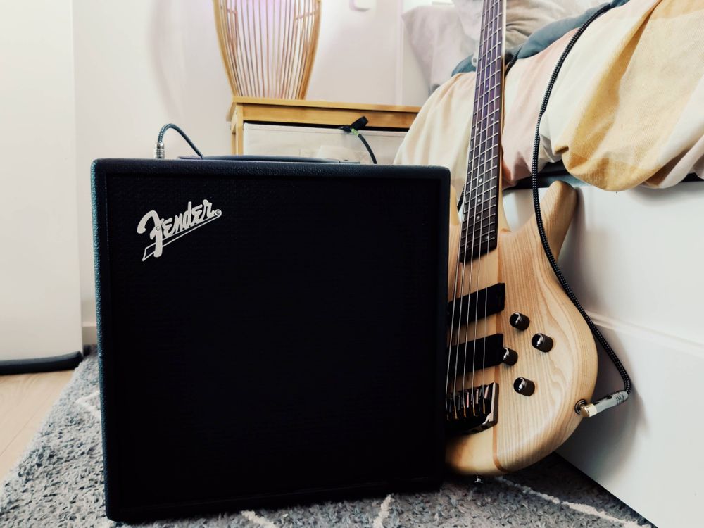Pic of a fender Lt25 amp next to a 5 string bass