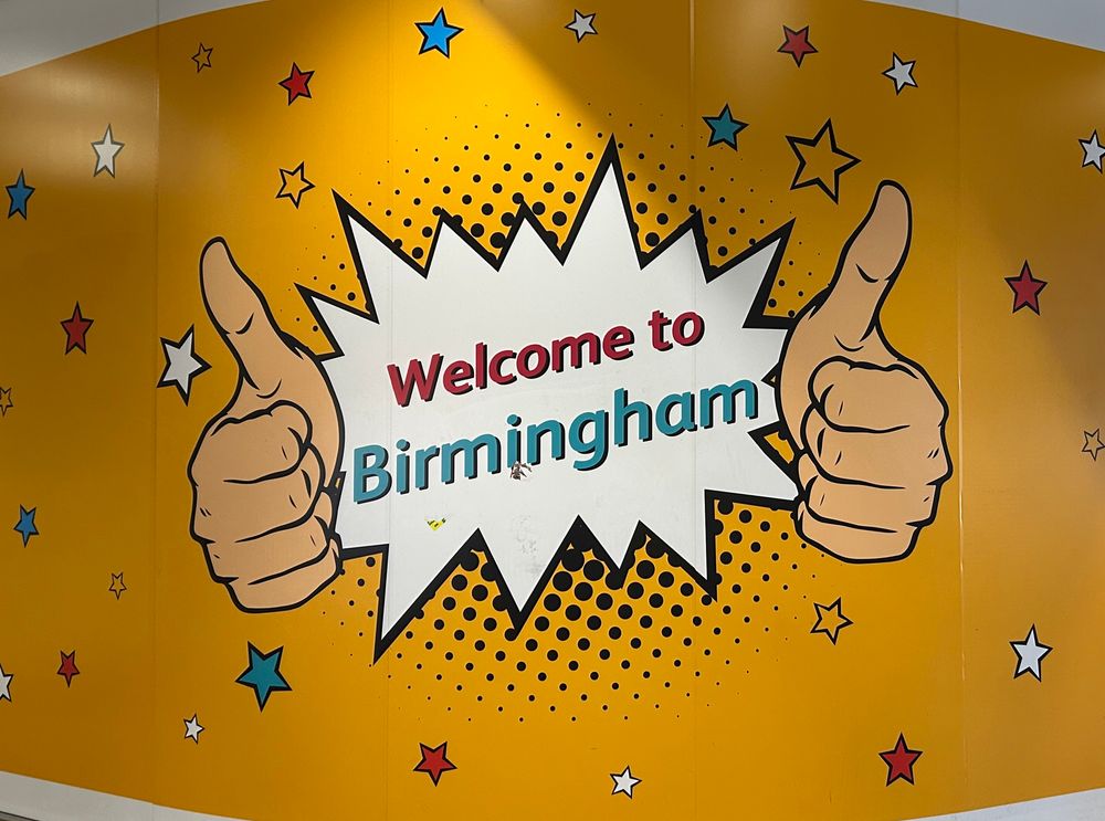 Welcome to Birmingham sign with yellow background and pop art style text. 