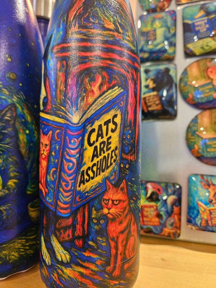 A colorful design on a bottle that reads "Cats are assholes" :)