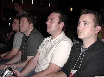 picture of a bunch of guys sitting and staring blankly at something off camera