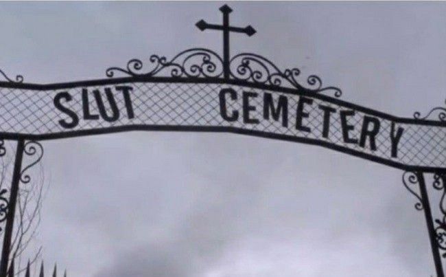 cemetery gate that says slut cemetery wit a cross on top