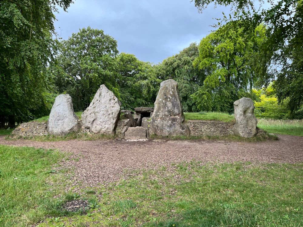View of the entrance of Neolithic burial chamber, with four tall standing stones built into the facade.