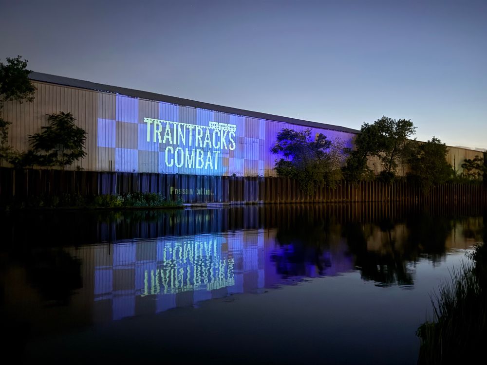 Traintracks Combat projected on a warehouse across the Chicago river. 