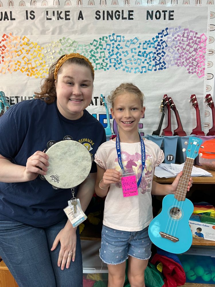 Music teacher and student holding musical instruments 