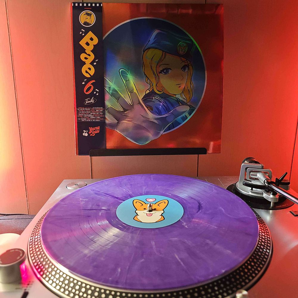 A purple and white smoke vinyl record sits on a turntable. Behind the turntable, a vinyl album outer sleeve is displayed. The front cover shows an anime woman wearing police uniform holding her hand out in a stop motion.