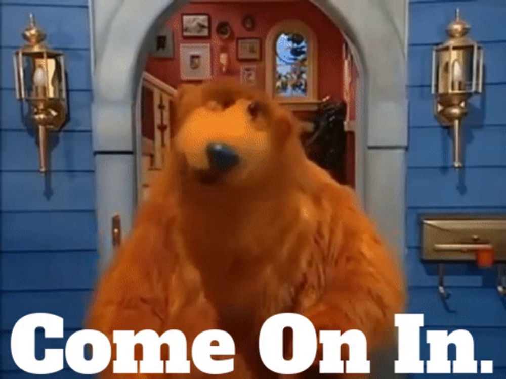 a bear is standing in front of a blue house with the words come on in