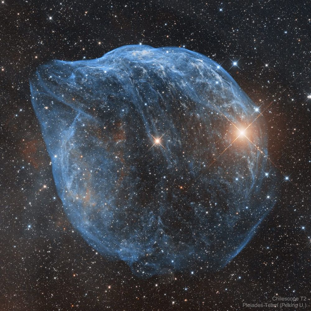 Glowing blue cosmic cloud looking sort of like a dolphin.


