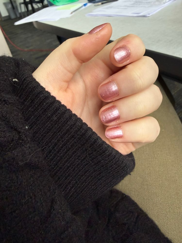 hand posed to show baby pink foil nail polish