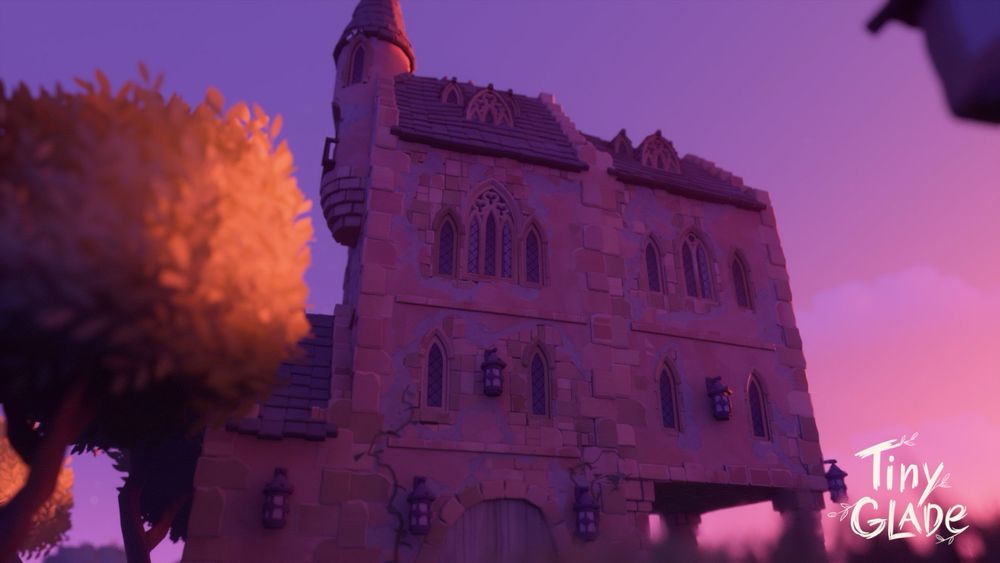 Un fotograma del juego Tiny Glade en el que se ve un edificio con muchas ventanas y un torreón con la luz del atardecer y colores cálidos