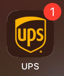 The UPS app tile on iOS with visual bug showing white edges around its four corners