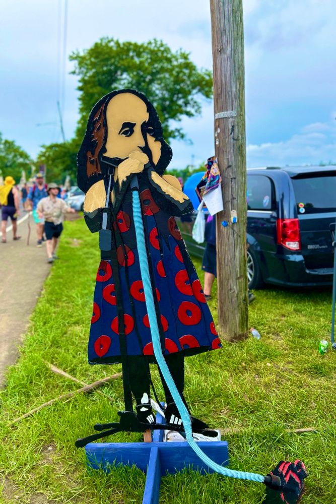 Ben Franklin playing a vacuum sign to mark shakedown street. The Mann 2025