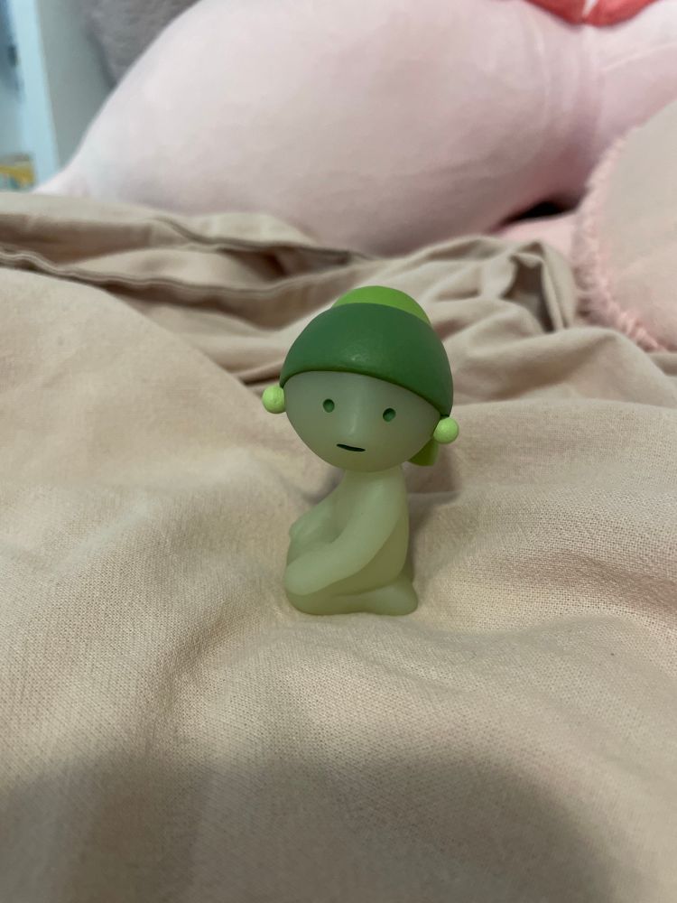 cute smiski or green goofy ahh little guy posing like the famous painting of girl with pearl earring