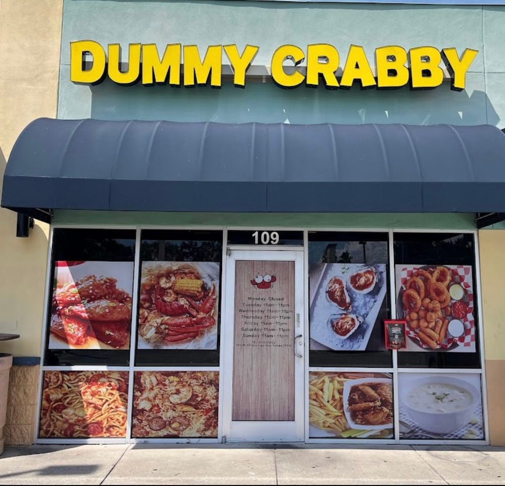 A strip-mall storefront of a crab restaurant called "Dummy Crabby."