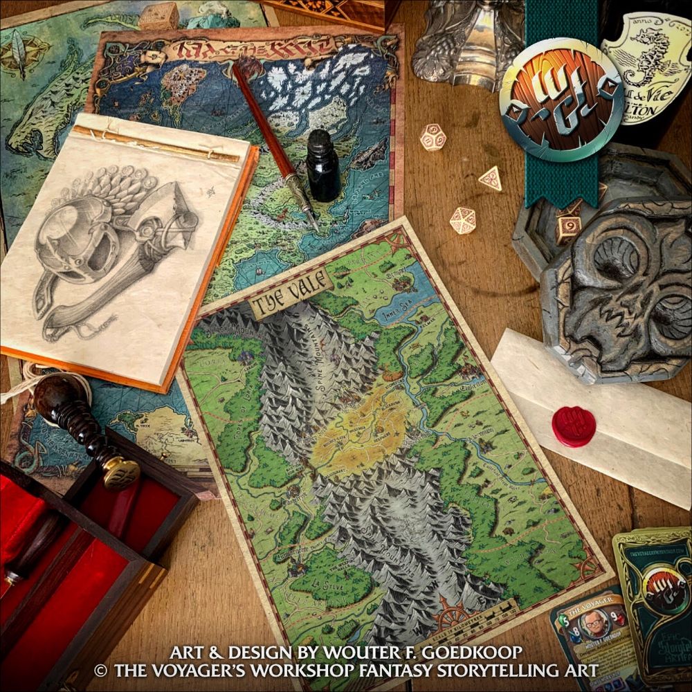 A photo of a wooden table with a number of items laying on it, including: three fantasy maps, a sketch pad with a pencil illustration of a helm and an axe, a wood carved custom dice box, a wax sealed piece of parchment and some whimsical business card from the Voyager’s Workshop.