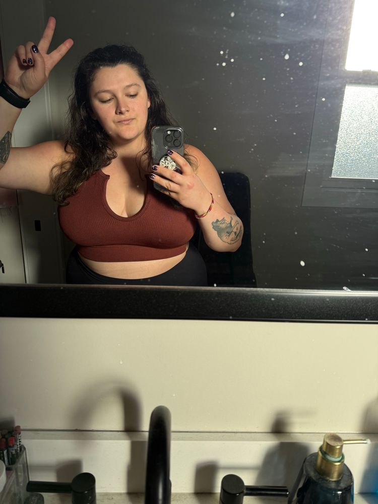a mirror selfie with me throwing a peace sign. I am wearing a new cute brown crop top. My mirror does need to be cleaned 