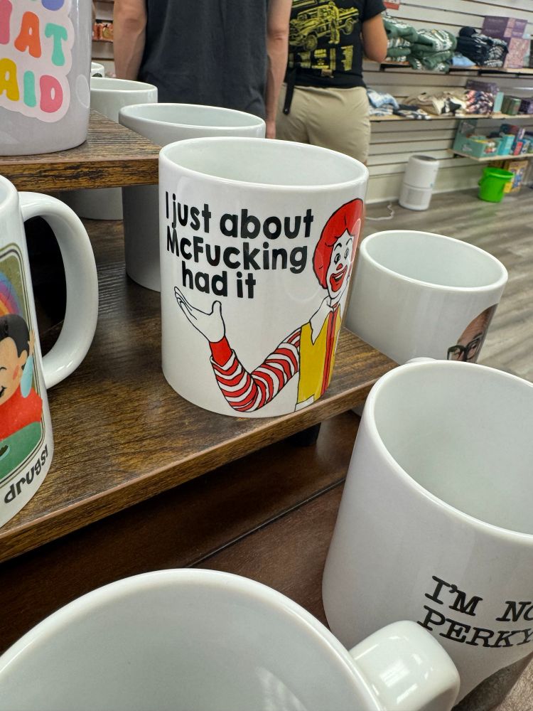 A coffee mug with a picture of Ronald McDonald that reads “I just about McFucking had it”