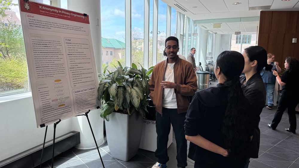 Photo of a Carnegie Mellon University Privacy Engineering student sharing their research at a poster session
