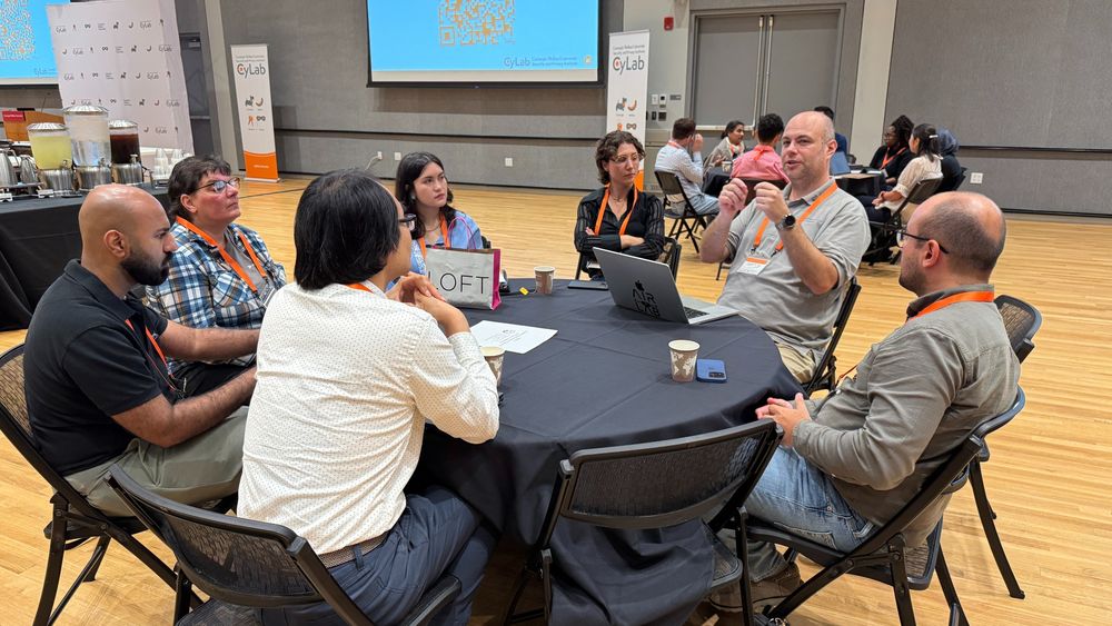 Photo of attendees talking during a breakout session at the CyLab Robotics Security and Privacy Workshop