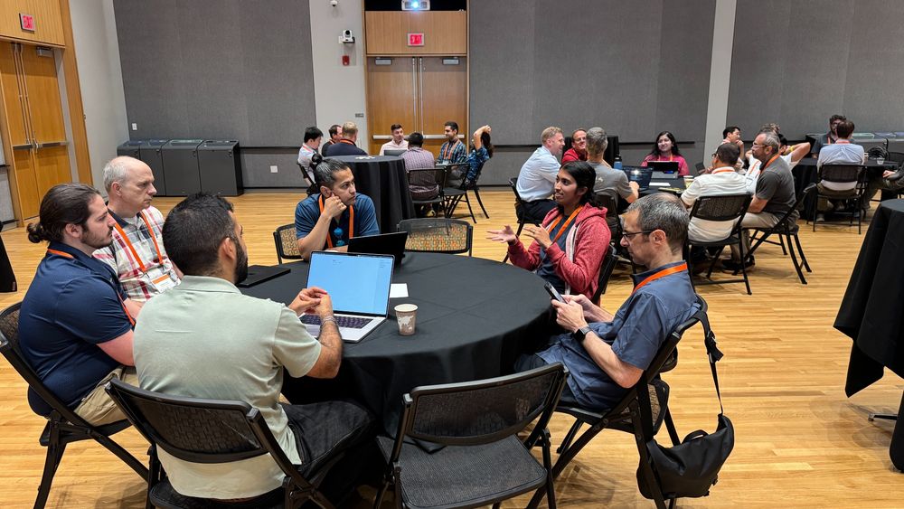 Photo of attendees talking during a breakout session at the CyLab Robotics Security and Privacy Workshop