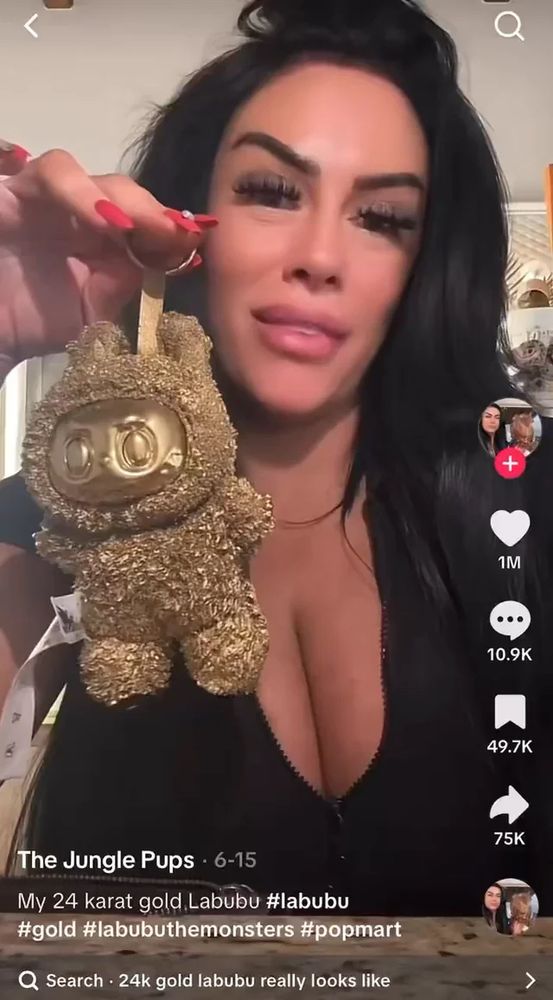 a screenshot of the original 24 karat gold labubu tiktok meme with a woman holding a golden labubu on a keyring