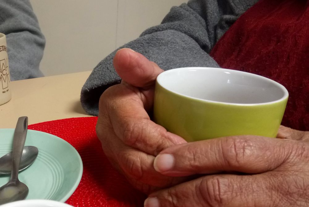 Hands holding a green mug