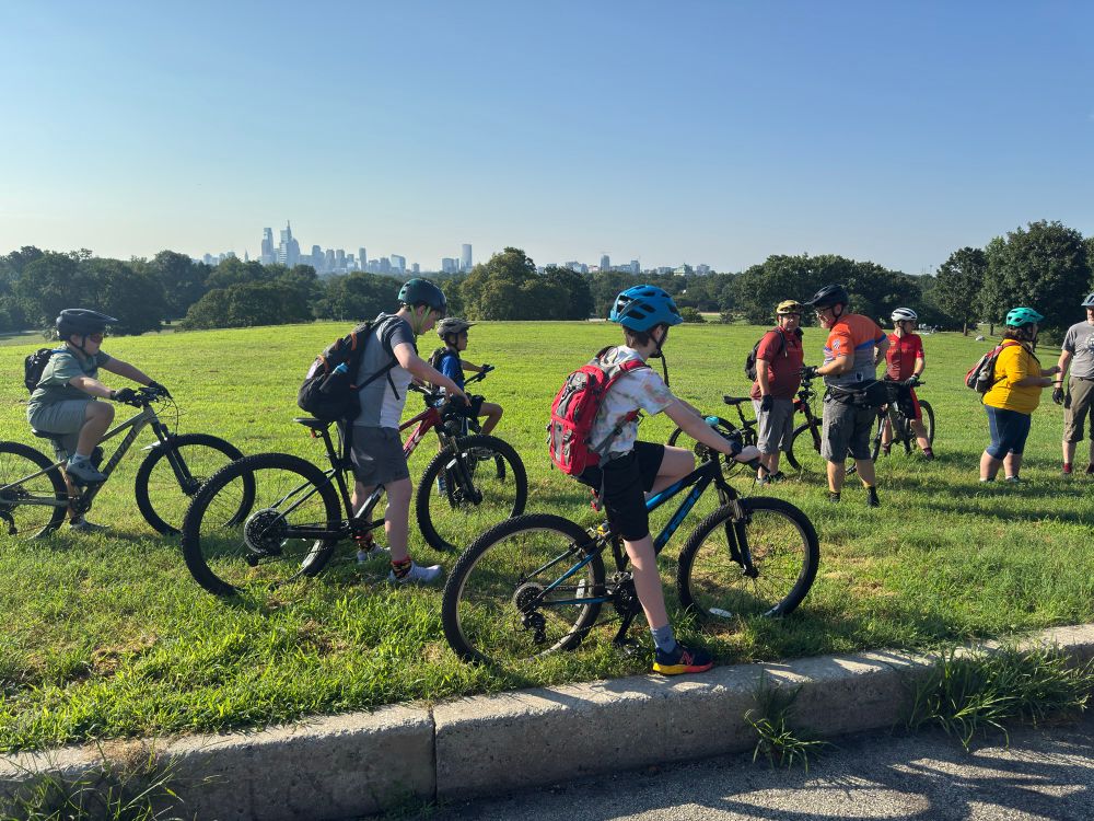 Finn and group of mountain bike riders at Belmont overlooking center city Philadelphia